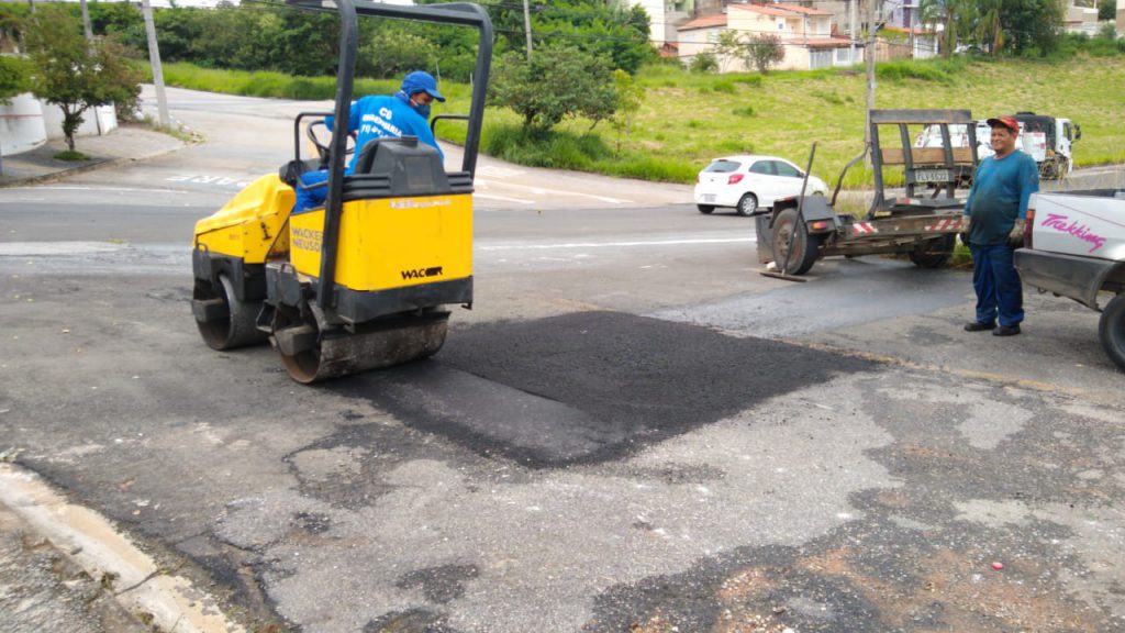 Máquina de tapa-buraco passando na via